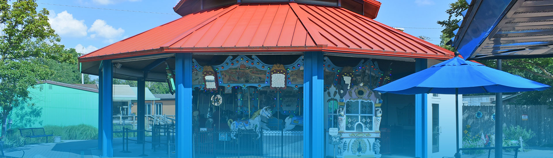 Carousel with a red roof during a sunny day