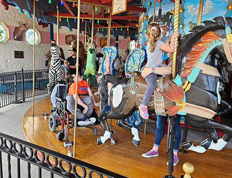 Zoo guests riding the carousel