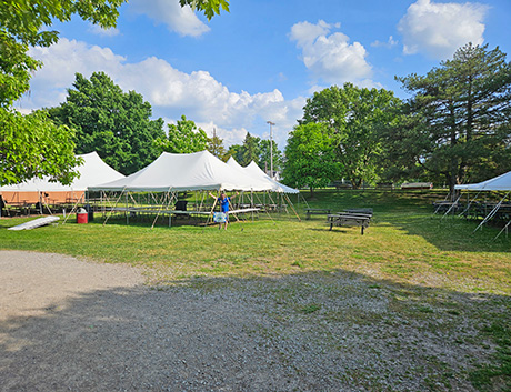 Event Field with Events Tents and Zoo employee giving thumbs up