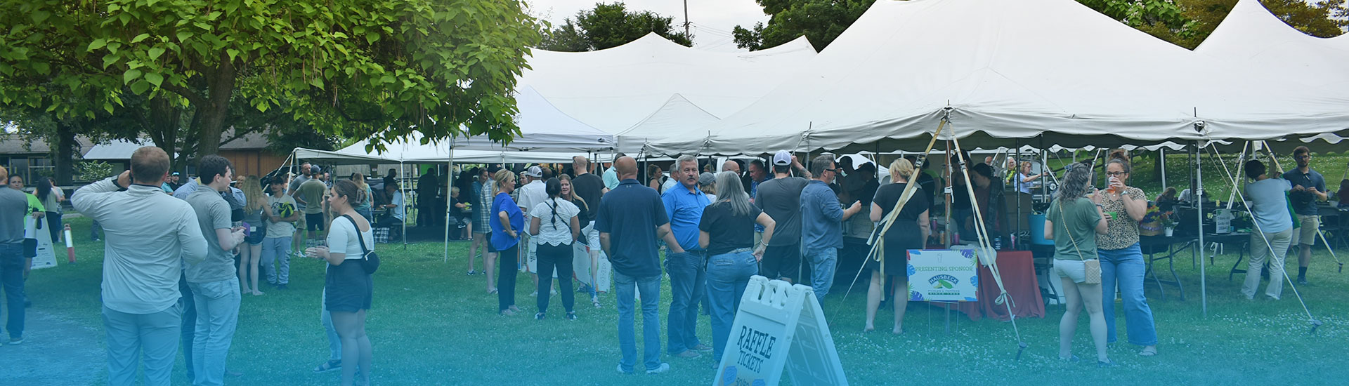 Large group od people in the events field talking and enjoying themselves