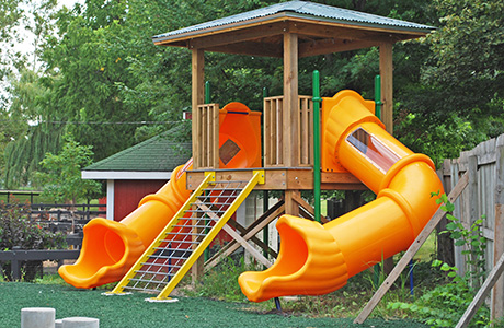 Playscape structure with two orange slides