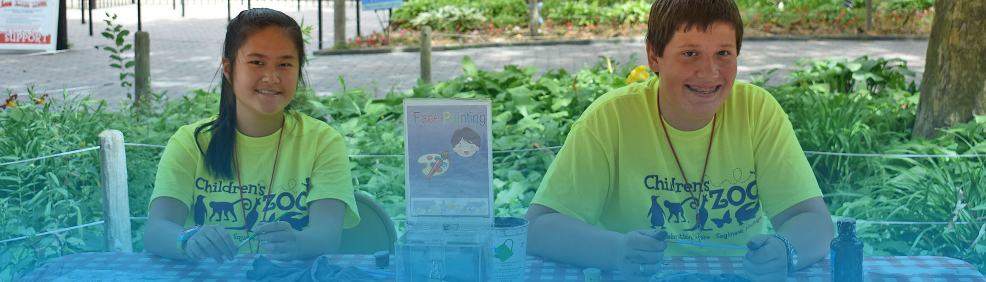 Two ZooCrew team members sitting happily at a table