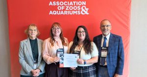 AZA Accreditation Representatives from the Saginaw Zoo holding a AZA accreditation certificate